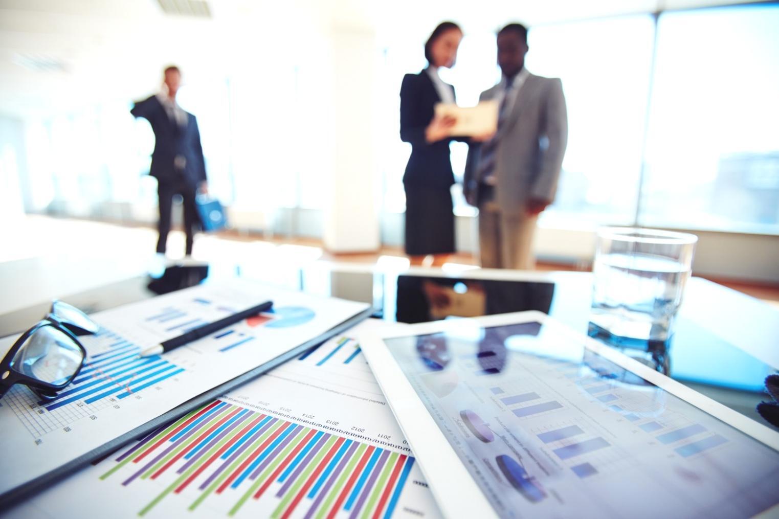 Modern financial workspace with data visualization displays